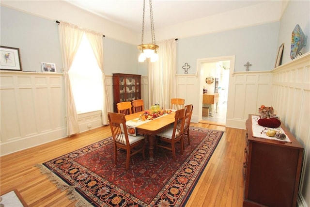 dining room with a notable chandelier and light wood-type flooring