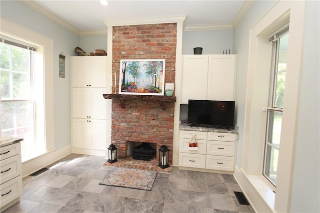 tiled living room featuring a fireplace, crown molding, and brick wall