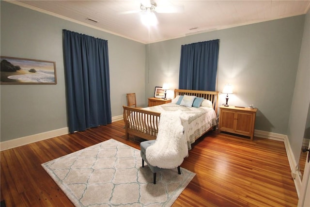 bedroom with ceiling fan, ornamental molding, and dark hardwood / wood-style floors