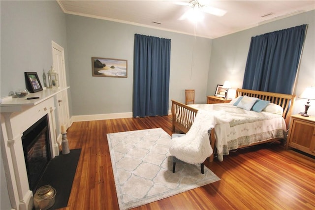 bedroom featuring ornamental molding, ceiling fan, and dark hardwood / wood-style floors