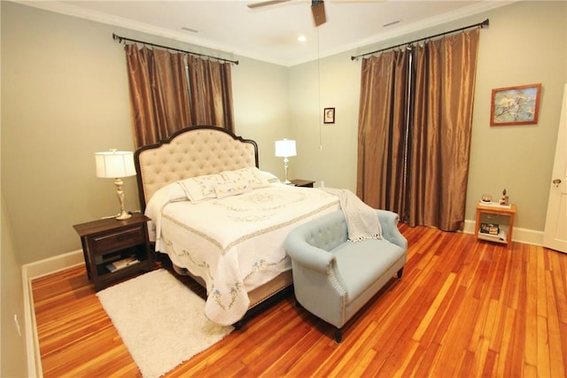 bedroom with ceiling fan, hardwood / wood-style flooring, and ornamental molding