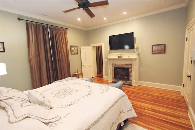 bedroom featuring ceiling fan, ornamental molding, and light hardwood / wood-style floors