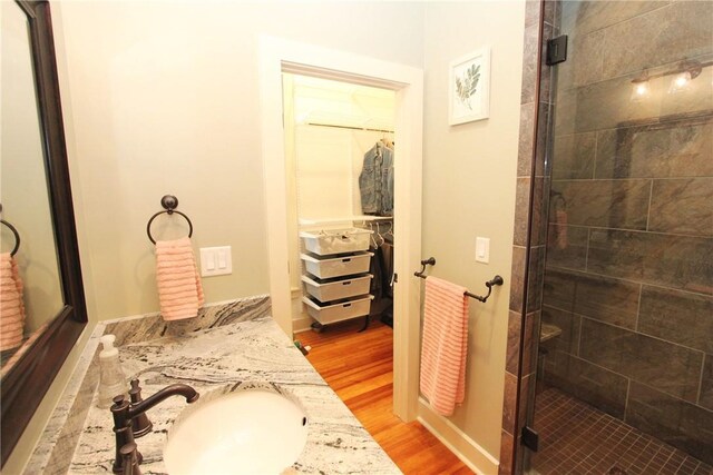 bathroom featuring vanity, hardwood / wood-style floors, and walk in shower