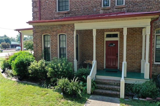 view of exterior entry with a porch