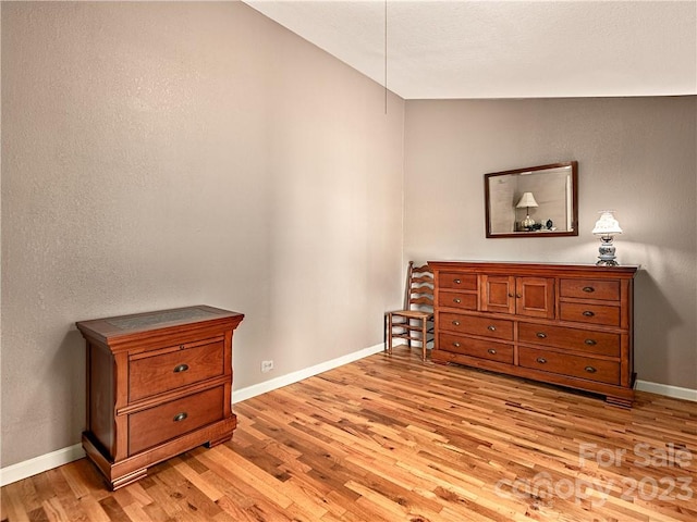 bedroom featuring vaulted ceiling and light hardwood / wood-style flooring