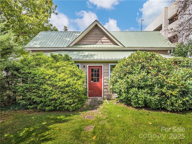 view of front of home with a front yard and metal roof