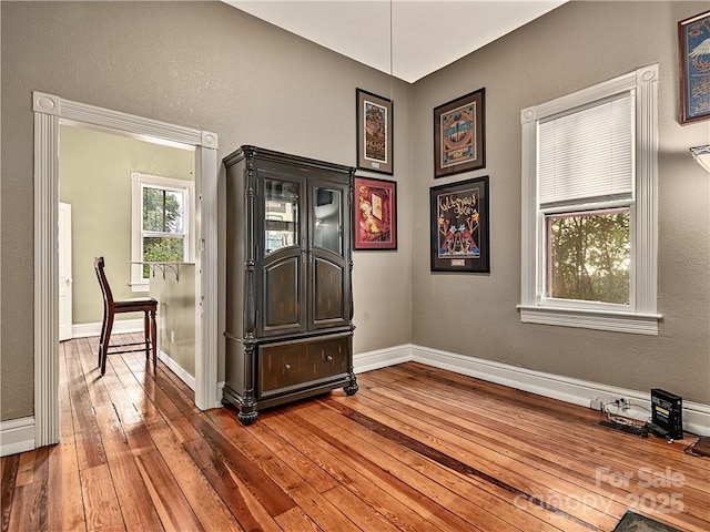 empty room featuring hardwood / wood-style flooring and baseboards