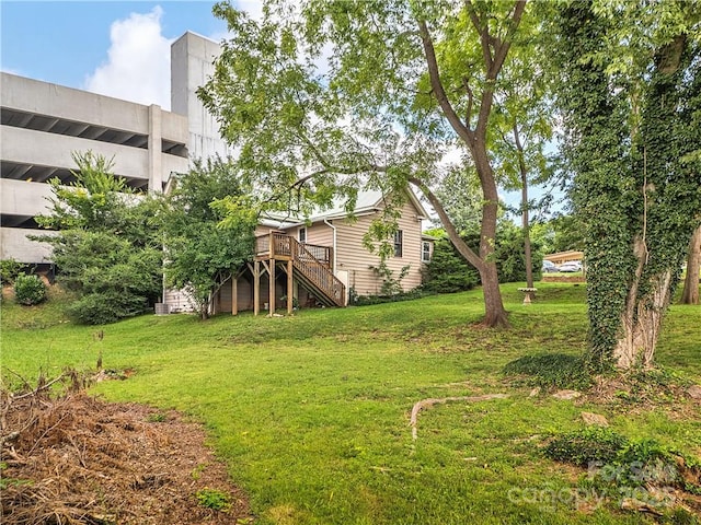 view of yard with a deck and stairs