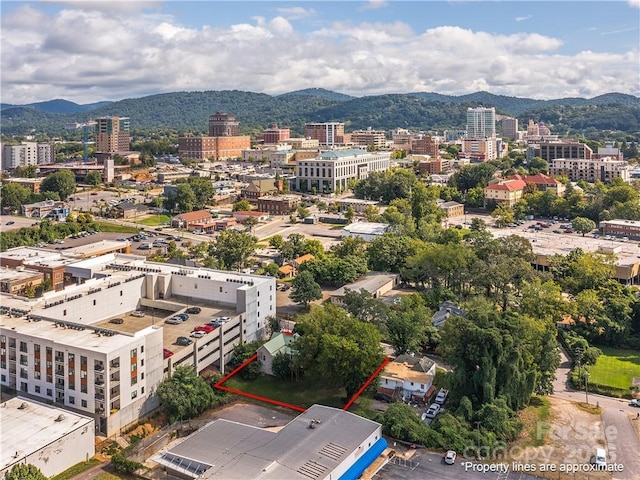 birds eye view of property with a view of city and a mountain view
