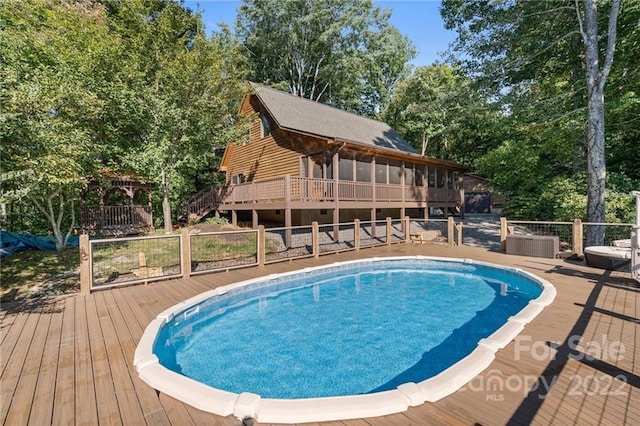 view of swimming pool with a wooden deck