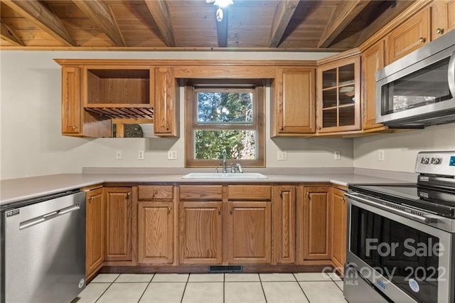 kitchen featuring wood ceiling, beam ceiling, stainless steel appliances, and sink