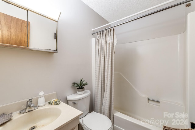 full bathroom featuring vanity, toilet, shower / tub combo with curtain, and a textured ceiling