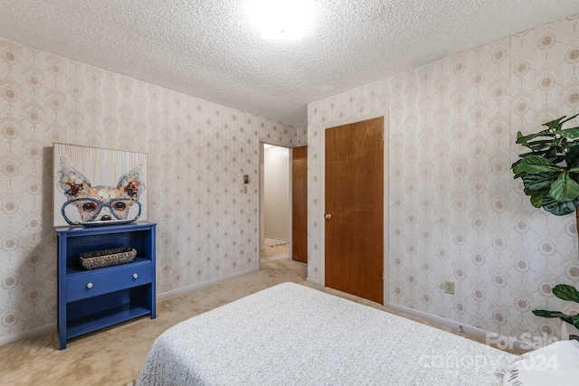 bedroom featuring carpet and a textured ceiling