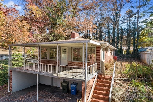 rear view of house featuring a porch