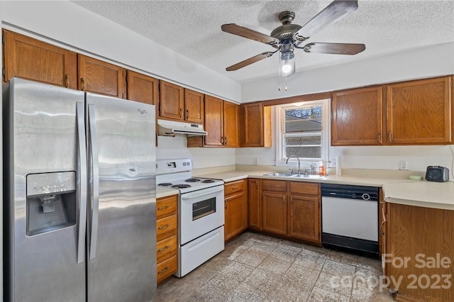 kitchen featuring white appliances, a textured ceiling, ceiling fan, and sink