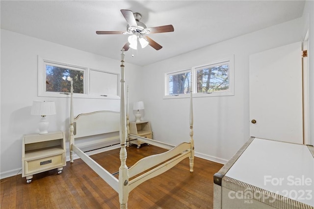 bedroom with ceiling fan and dark hardwood / wood-style flooring