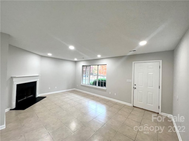 unfurnished living room with light tile floors