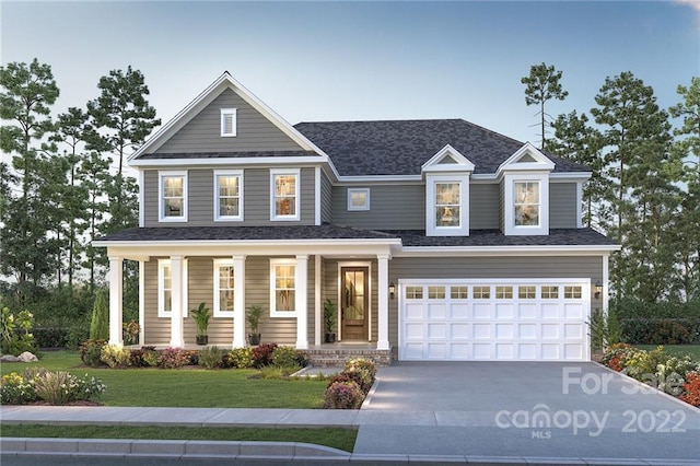 craftsman-style house featuring covered porch, a front yard, and a garage