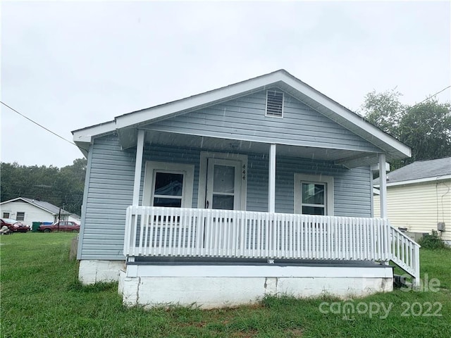 view of front of property with a front lawn and a porch