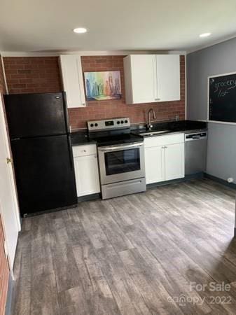 kitchen with electric stove, stainless steel dishwasher, light hardwood / wood-style floors, white cabinetry, and black fridge