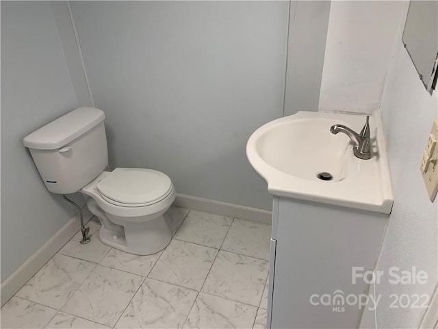 bathroom featuring toilet, tile flooring, and vanity