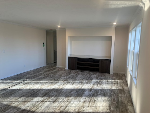 unfurnished living room with crown molding and dark wood-type flooring