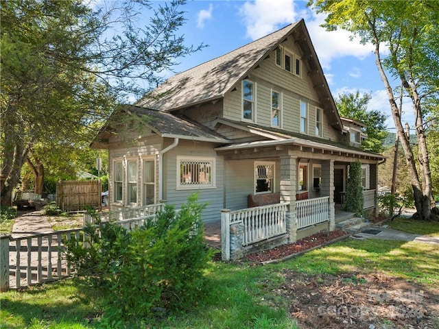 rear view of property with a porch