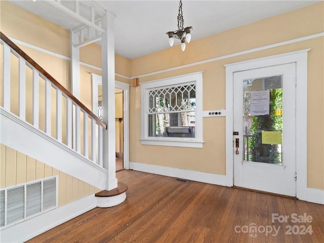 entryway with a chandelier and dark wood-type flooring