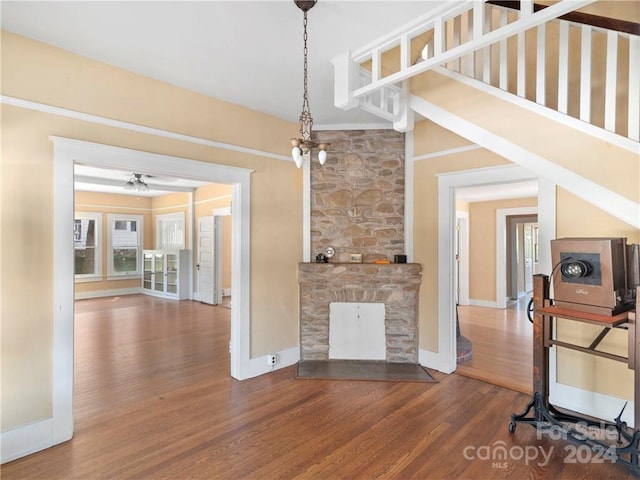 living room featuring a fireplace, hardwood / wood-style flooring, and ceiling fan