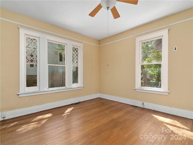 unfurnished room with ceiling fan and hardwood / wood-style flooring