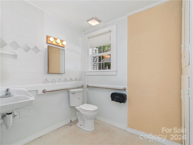 bathroom featuring tile flooring, toilet, and tile walls