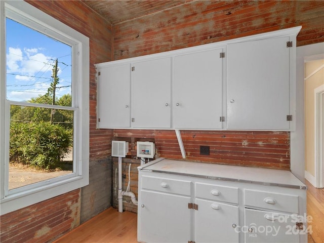 kitchen featuring white cabinetry, light hardwood / wood-style flooring, and a healthy amount of sunlight