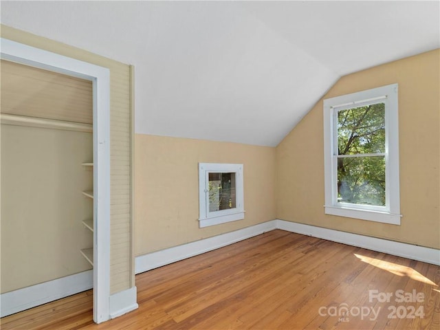 bonus room with lofted ceiling and light hardwood / wood-style flooring