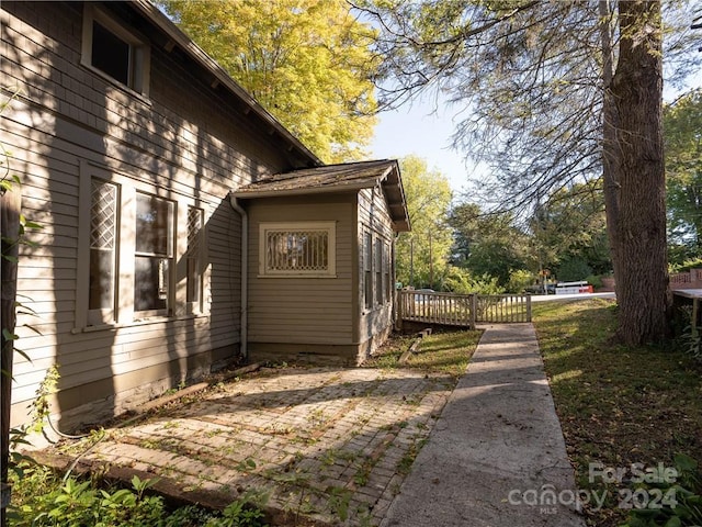 view of side of property featuring a wooden deck