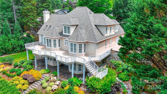 rear view of property featuring a deck