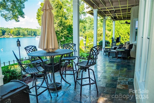 view of patio featuring a water view and grilling area