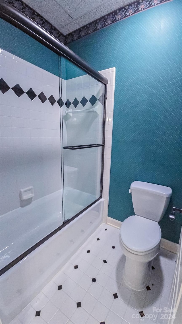 1563 Calls Lodge Ct, Morganton, NC 28655 - bathroom featuring wallpapered walls, baseboards, bath / shower combo with glass door, toilet, and tile patterned floors