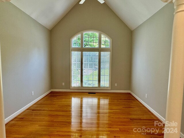 unfurnished room featuring light hardwood / wood-style flooring, ceiling fan, and lofted ceiling