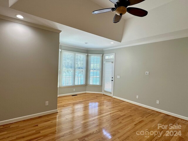 spare room with light hardwood / wood-style floors, ceiling fan, and crown molding