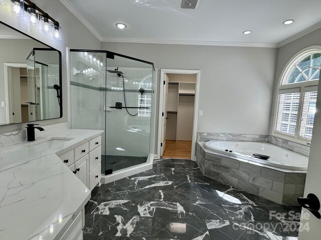 bathroom with plus walk in shower, vanity, and ornamental molding