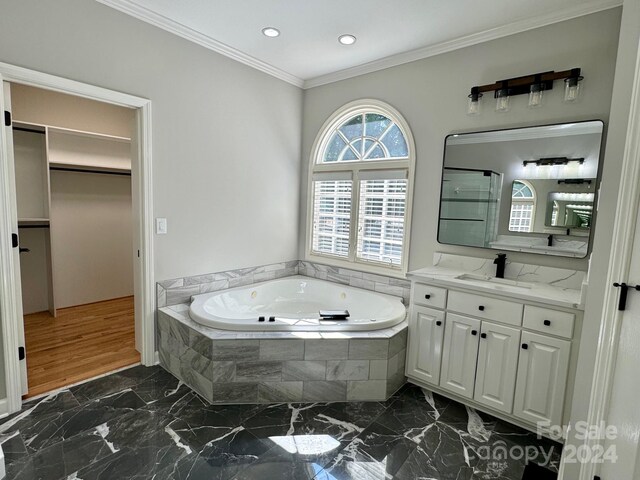 bathroom with hardwood / wood-style floors, vanity, separate shower and tub, and ornamental molding