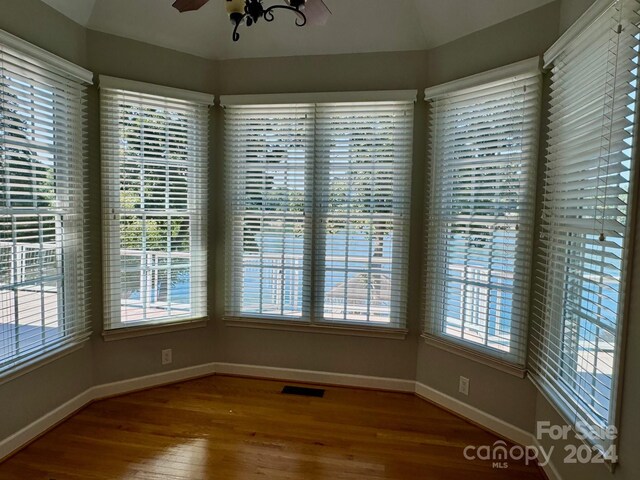 interior space with hardwood / wood-style floors, ceiling fan, and a wealth of natural light