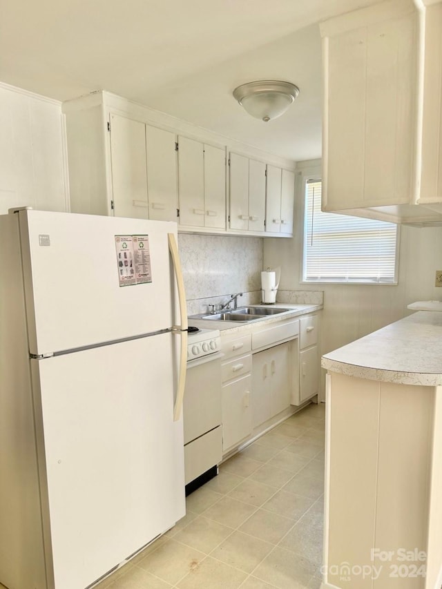 kitchen featuring light tile patterned flooring, sink, and white appliances