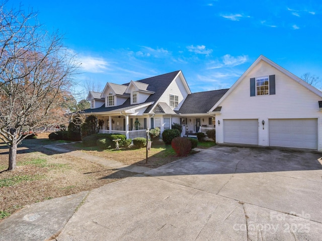 cape cod home with covered porch and a garage