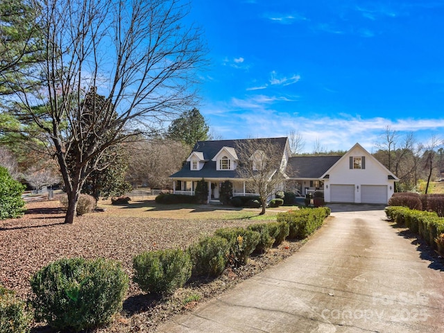 cape cod house with a porch and a garage