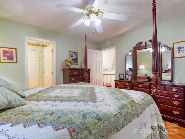 bedroom with ceiling fan and a textured ceiling