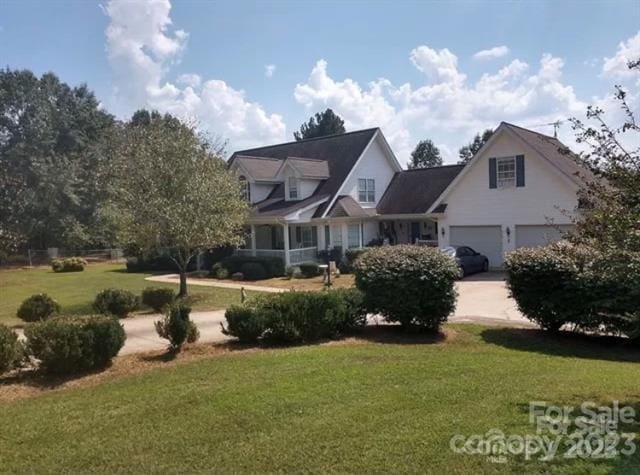 view of front of house with a front lawn and a garage