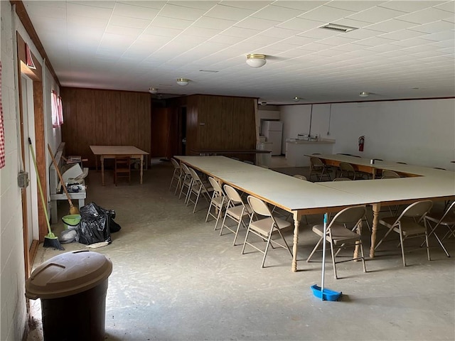 dining room with wooden walls