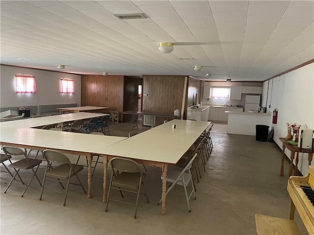 kitchen with wooden walls and concrete floors