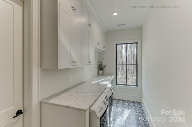 laundry room featuring light tile floors and washer / dryer